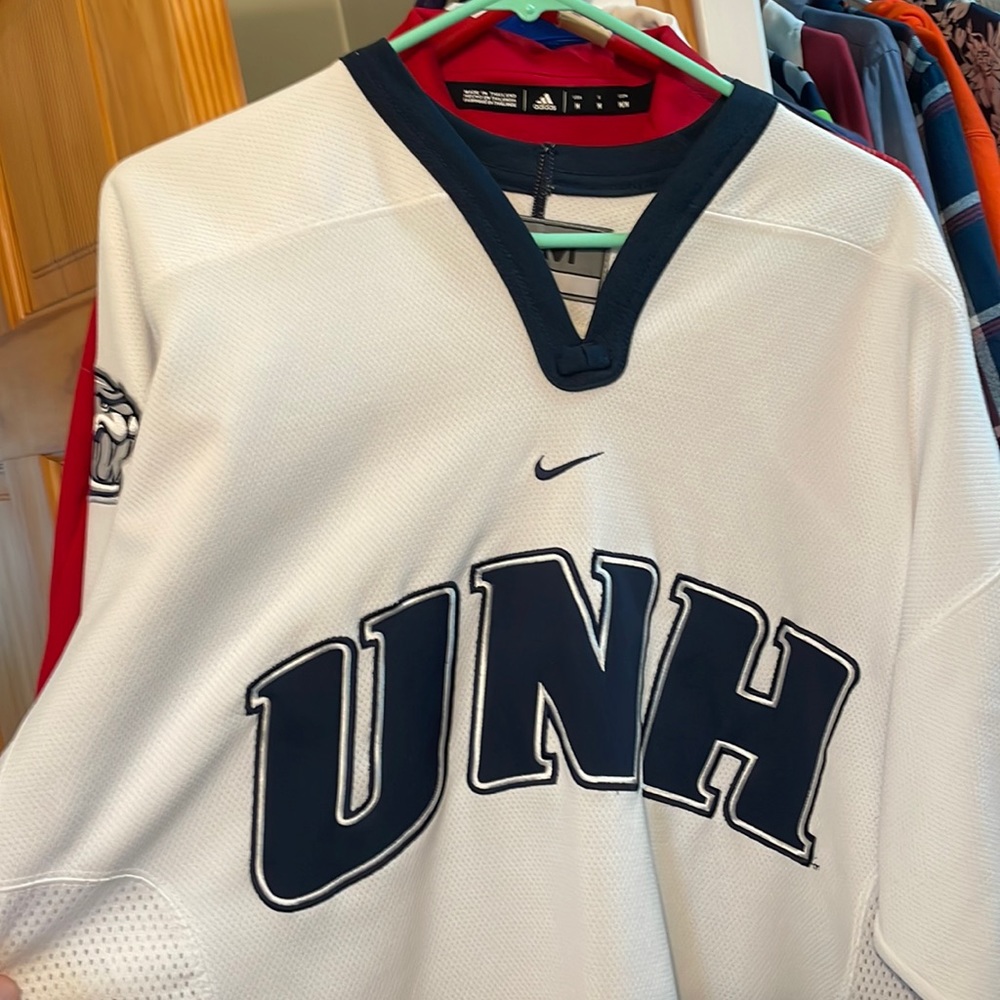 U of New Hampshire hockey jersey.
